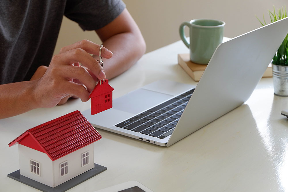 Buildnest team member managing Airbnb-style rental operations from a laptop — coordinating guest stays, security, and property tasks in Niagara Region.