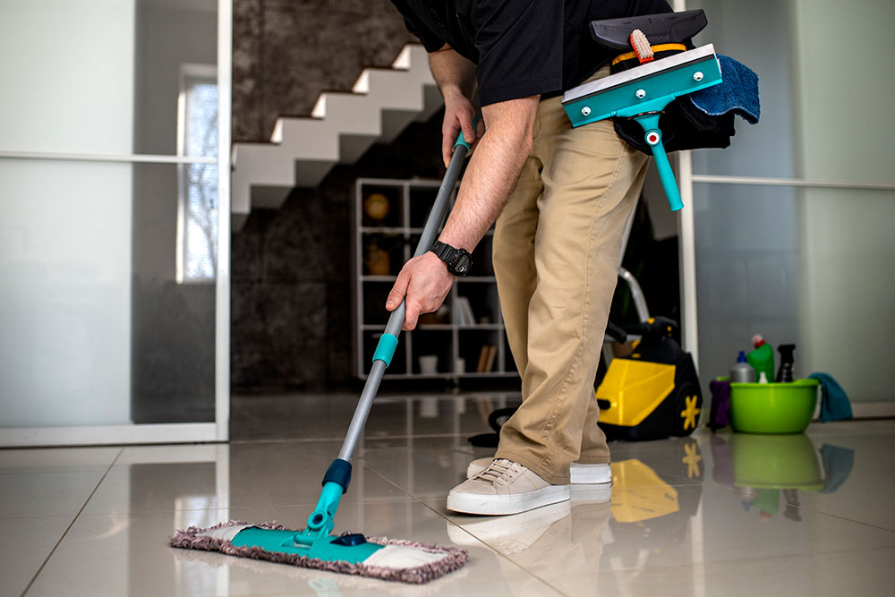 Buildnest indoor cleaning service in action — professional mop cleaning over wood flooring, showcasing tidy and reliable maintenance for Niagara homes.