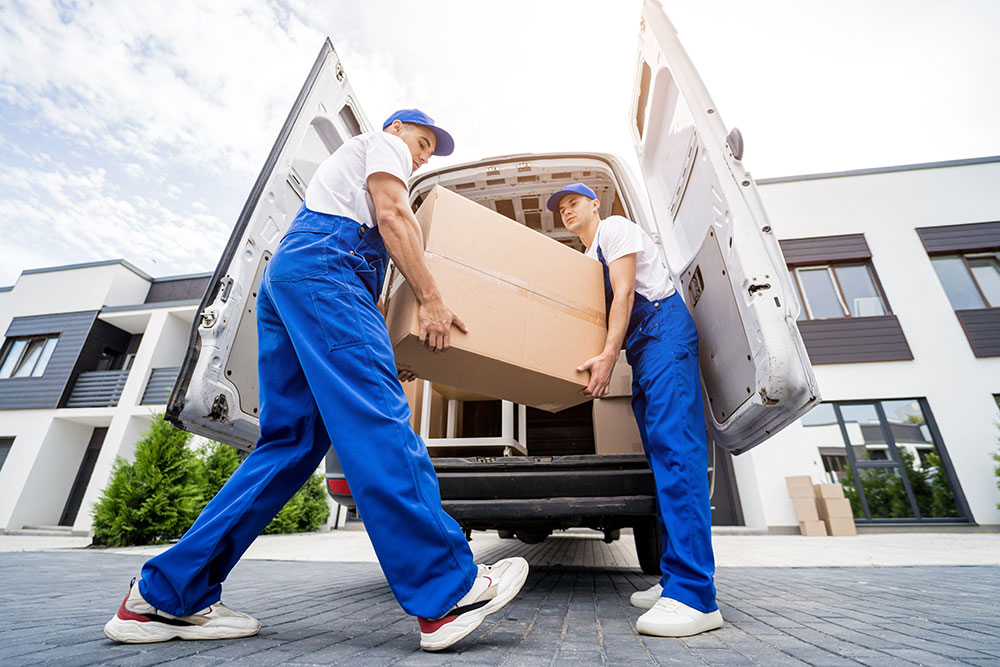 Buildnest moving team in workwear handling boxes and relocation tasks — delivering trusted moving, delivery, and property setup services across Niagara Region.