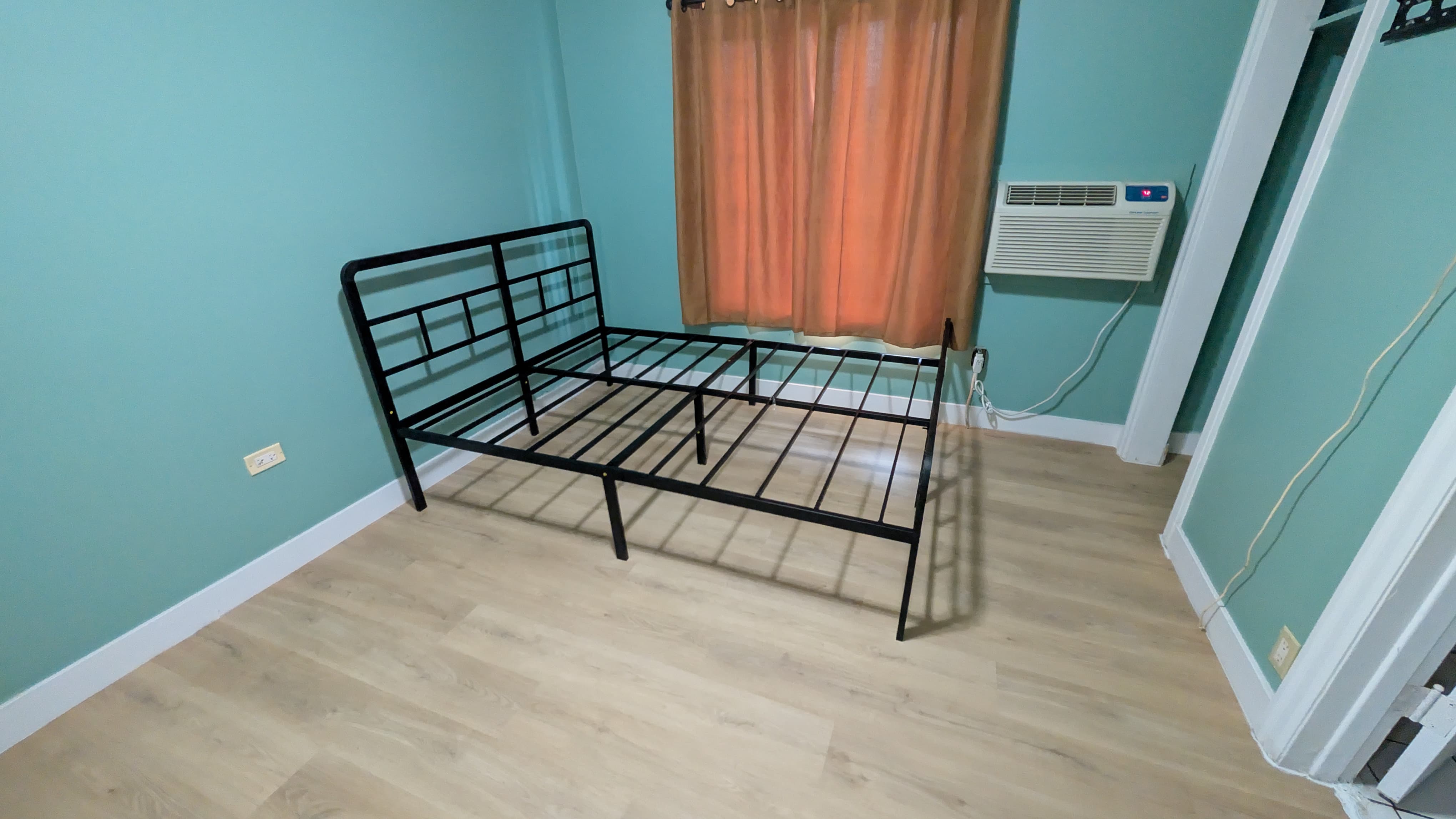 Black metal bed frame assembled by BuildNest in a Niagara home