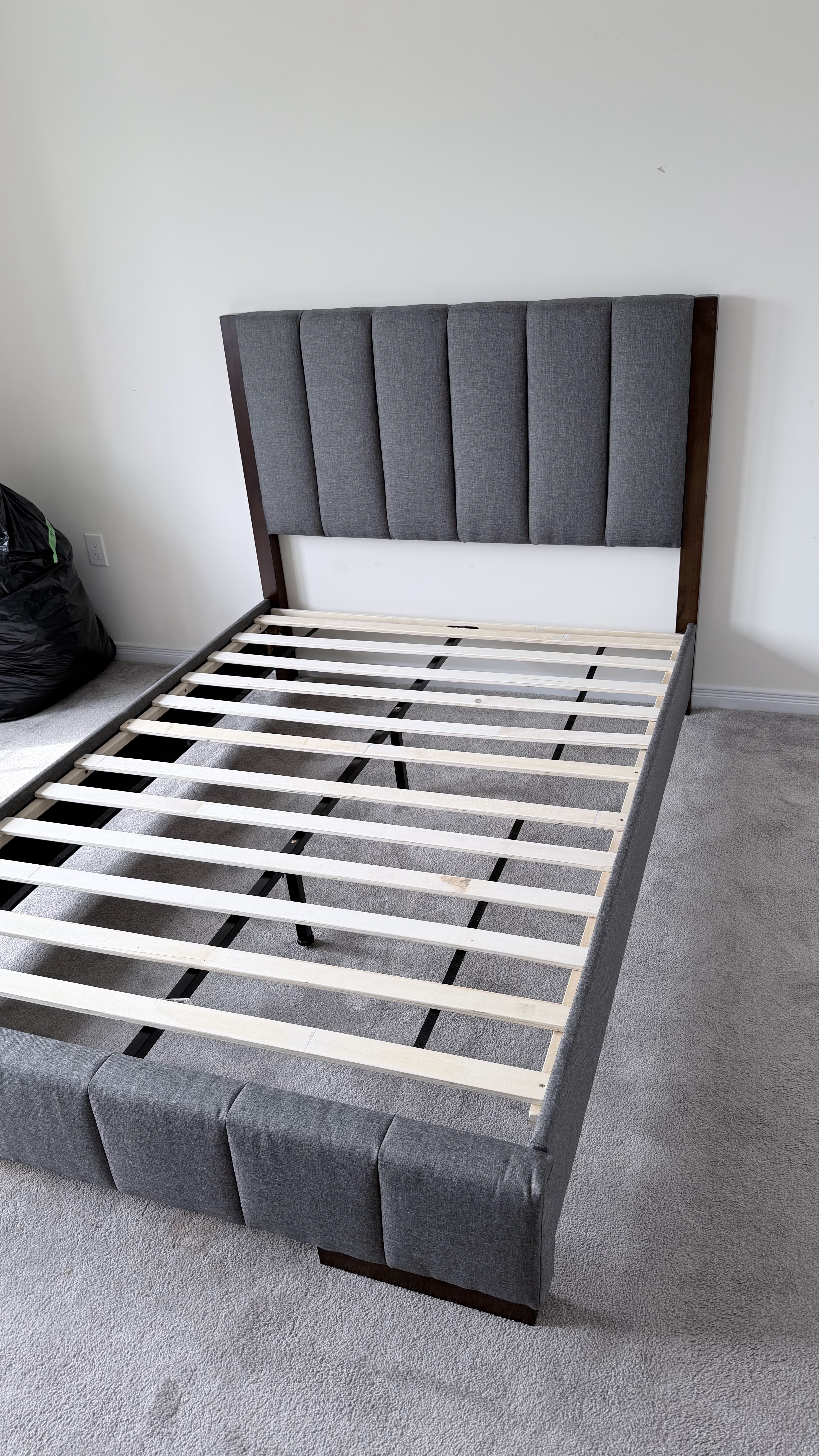 Upholstered bed with headboard and mattress set up by BuildNest in St. Catharines