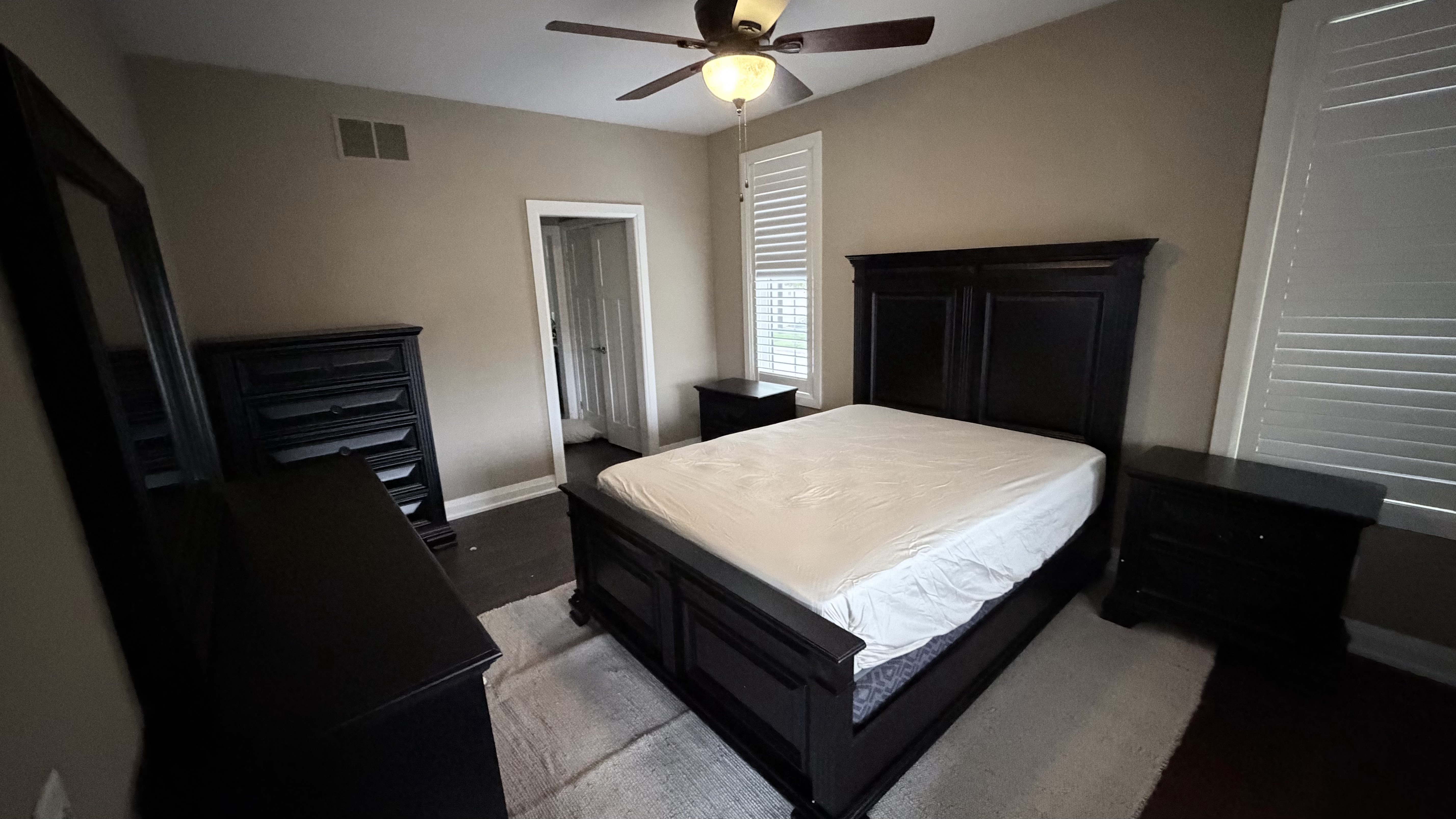 Finished bedroom with dark wood bed assembled by BuildNest in Niagara