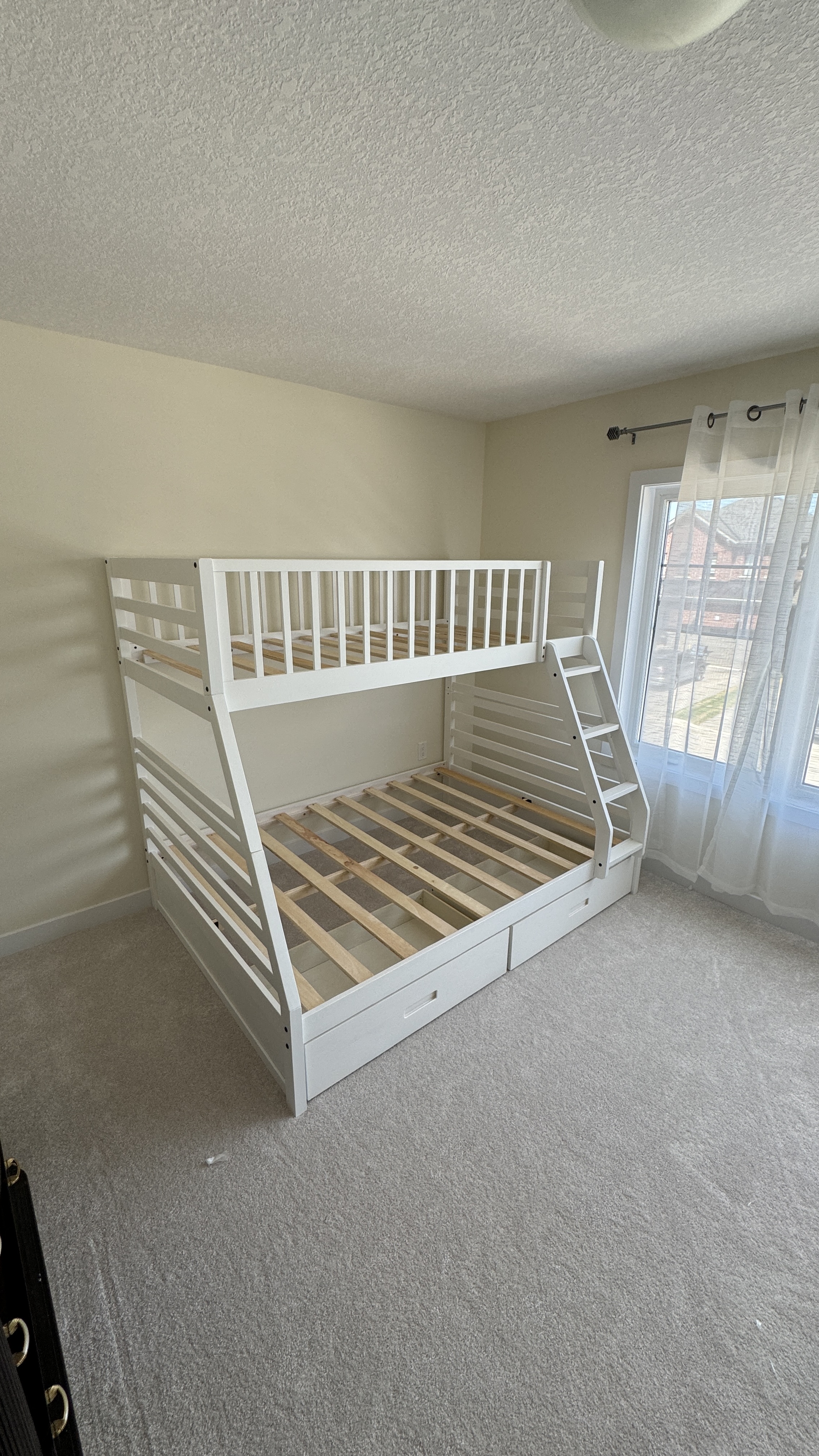 White wooden bunk bed with drawers assembled by BuildNest in St. Catharines